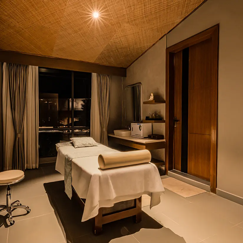 A quietly lit ARTH treatment room with a massage table